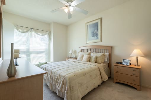 A comfortable sleeping space with soft lighting and plush carpeting.